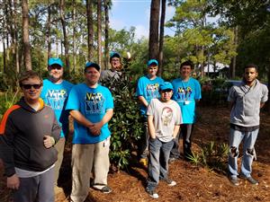 Extended Learning students pose next to magnolia tree planted in their honor Extended Learning students pose next to magnolia tree planted in their honor